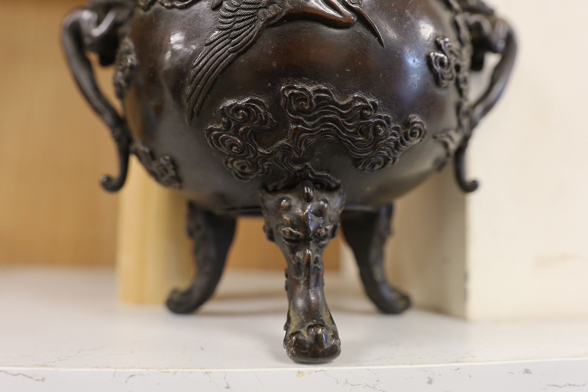 A Japanese bronze dragon handled censer with figural finial to cover, Meiji period, 24cm high. Condition - good